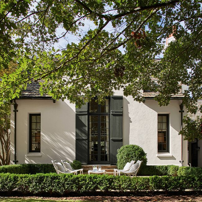 white-paint-stucco-house-dark-green-door-shutters-650x650